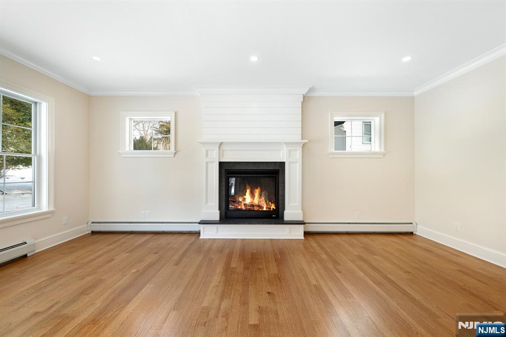 62 Colony Avenue Park Ridge, NJ 07656 - Photo 20 of 50 an empty room with wooden floor fireplace and windows