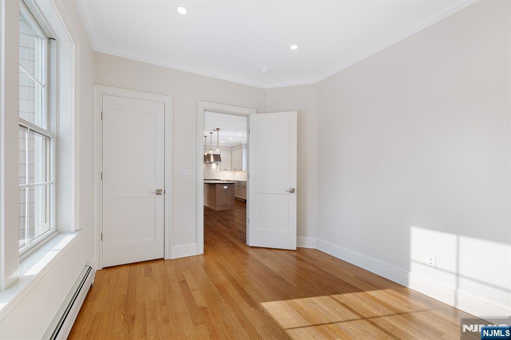 62 Colony Avenue Park Ridge, NJ 07656 - Photo 21 of 50 a view of empty room with wooden floor and cabinet
