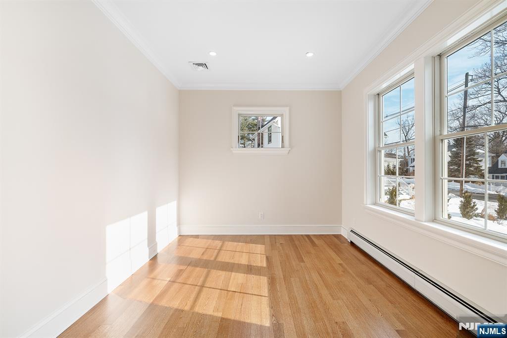 62 Colony Avenue Park Ridge, NJ 07656 - Photo 22 of 50 a view of an empty room with wooden floor and a window