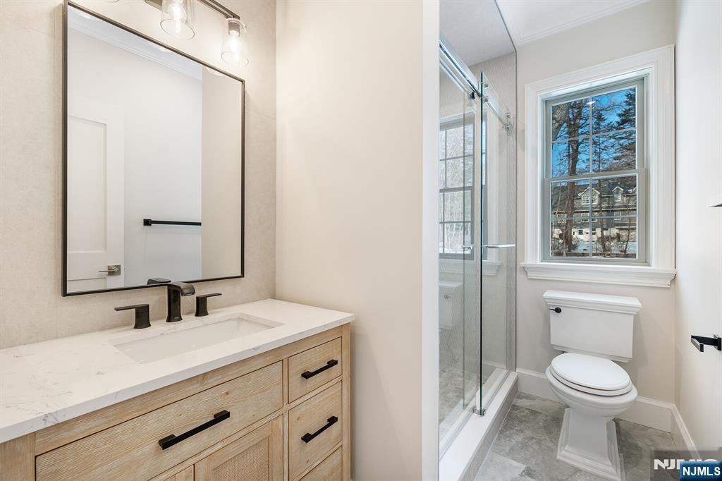 62 Colony Avenue Park Ridge, NJ 07656 - Photo 24 of 50 a bathroom with a sink a toilet a shower and a mirror