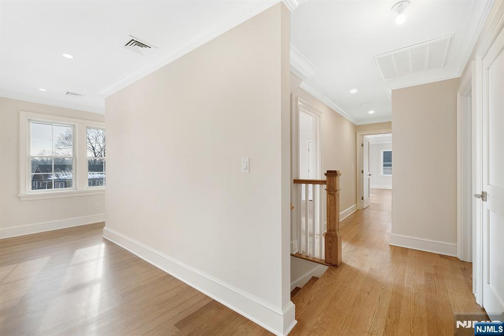 62 Colony Avenue Park Ridge, NJ 07656 - Photo 26 of 50 a view of a hallway with wooden floor and a bathroom