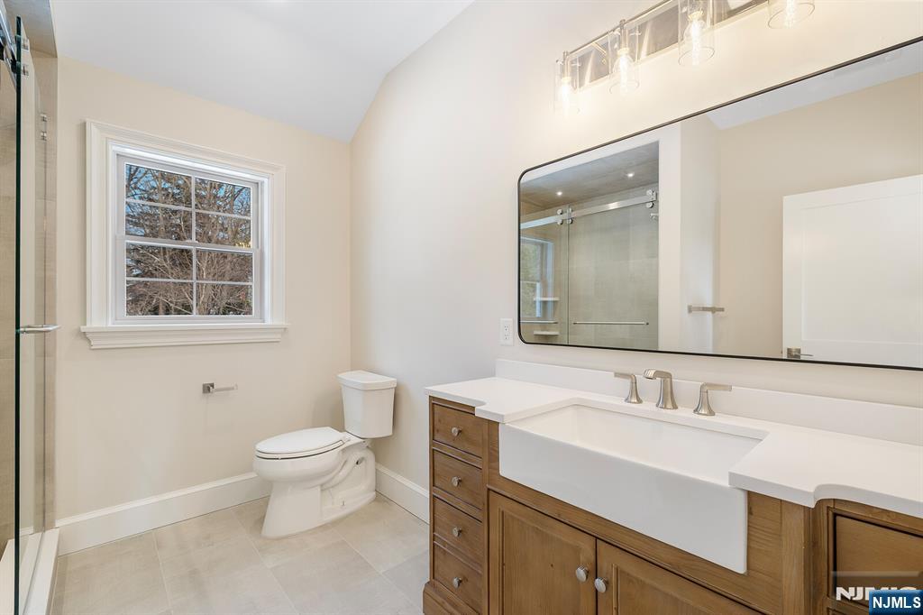 62 Colony Avenue Park Ridge, NJ 07656 - Photo 36 of 50 a bathroom with a toilet sink and mirror