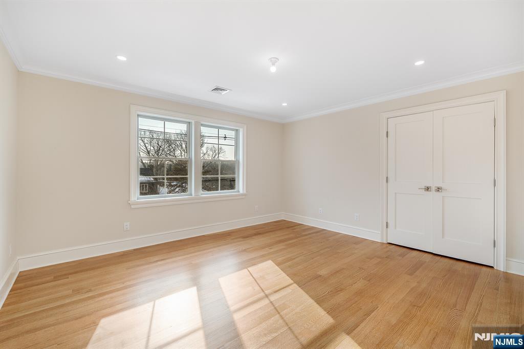 62 Colony Avenue Park Ridge, NJ 07656 - Photo 40 of 50 a view of empty room with wooden floor and fan