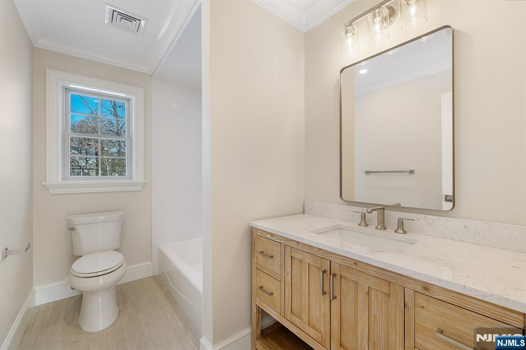 62 Colony Avenue Park Ridge, NJ 07656 - Photo 41 of 50 a bathroom with a toilet sink and a mirror