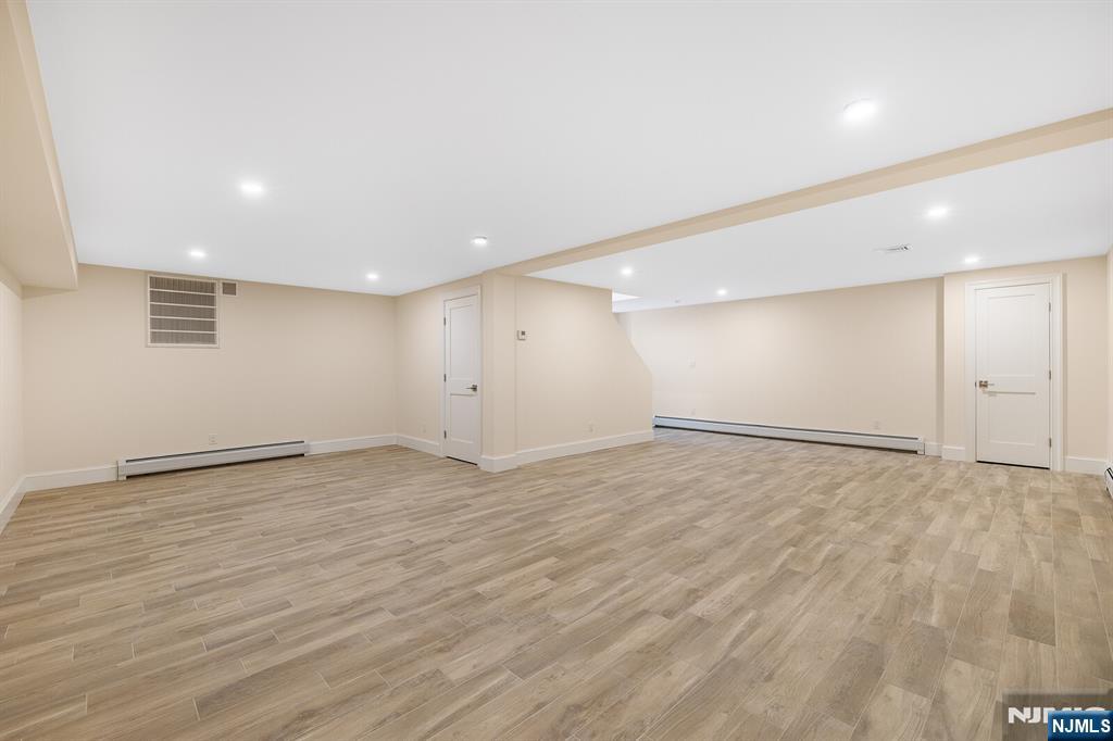 62 Colony Avenue Park Ridge, NJ 07656 - Photo 43 of 50 an empty room with wooden floor and windows