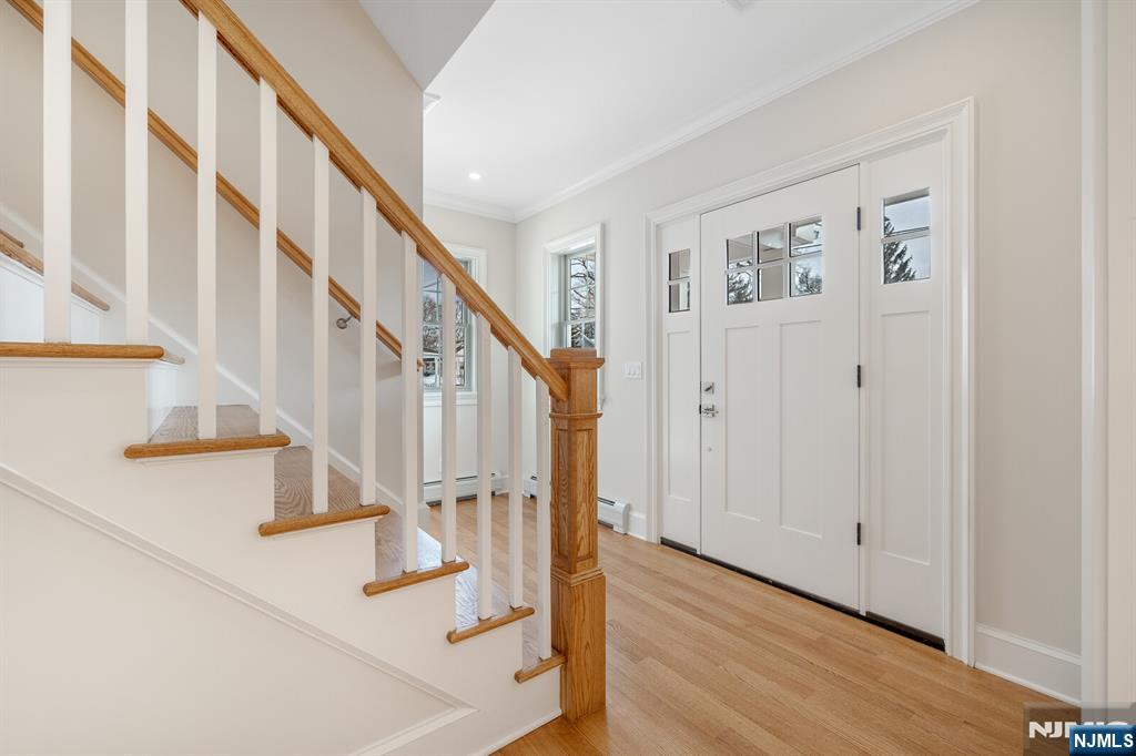 62 Colony Avenue Park Ridge, NJ 07656 - Photo 7 of 50 a view of staircase with lots of frames and white walls