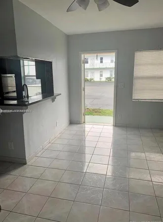 a view of a kitchen with an empty space and window