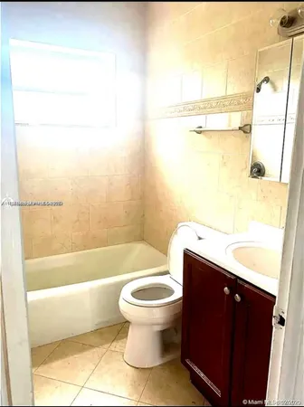 a bathroom with a bathtub and a toilet