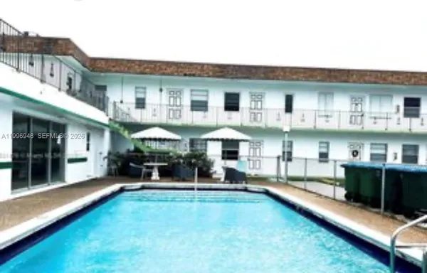 a swimming pool view with a outdoor seating space