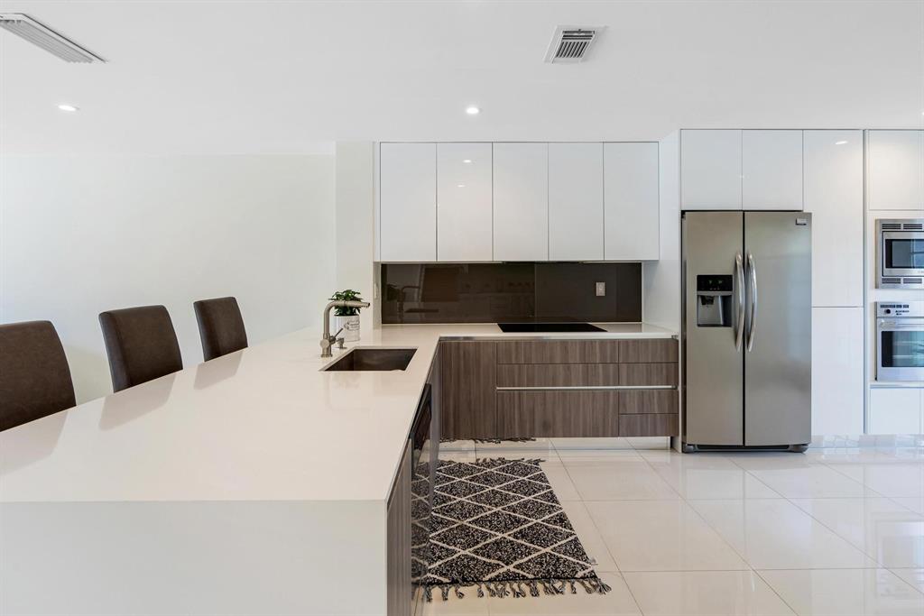 9703 Southwest 142nd Court Miami, FL 33186 - Photo 11 of 36 a kitchen with a refrigerator and a cabinets