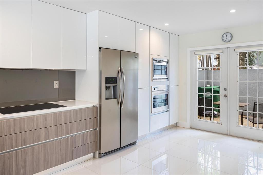 9703 Southwest 142nd Court Miami, FL 33186 - Photo 12 of 36 a view of a kitchen with refrigerator and more cabinets
