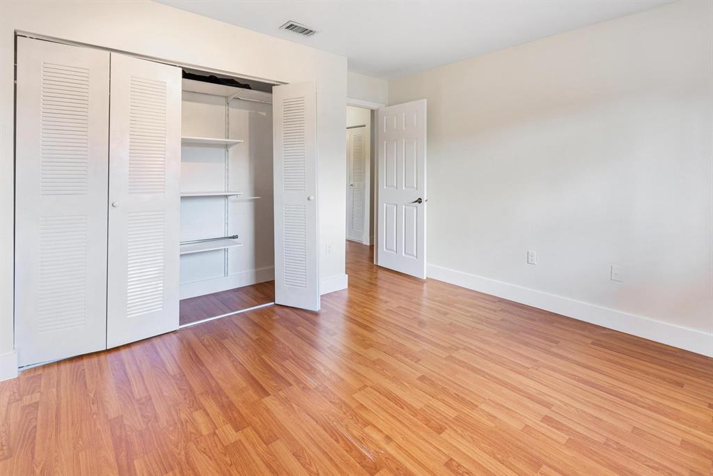 9703 Southwest 142nd Court Miami, FL 33186 - Photo 17 of 36 a view of empty room with wooden floor and entryway