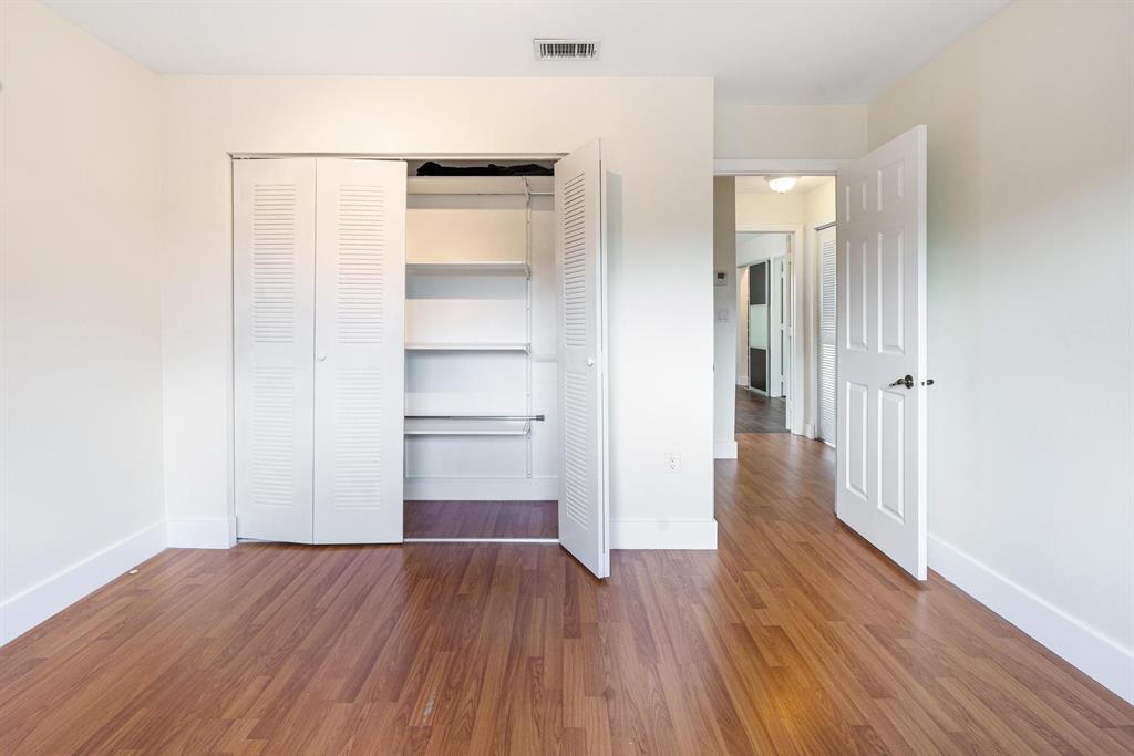 9703 Southwest 142nd Court Miami, FL 33186 - Photo 18 of 36 a view of a room with wooden floor