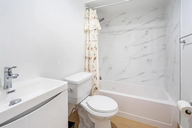 a bathroom with a sink toilet and shower