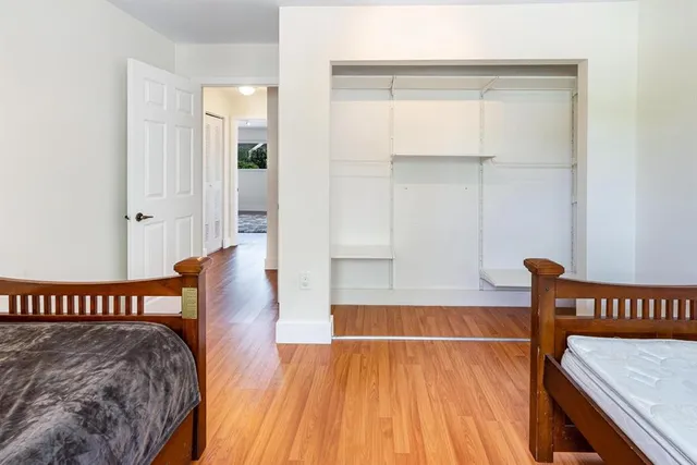 a view of bedroom with furniture and wooden floor