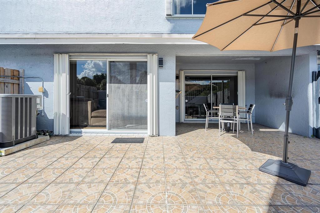 9703 Southwest 142nd Court Miami, FL 33186 - Photo 31 of 36 a backyard of a house with yard and seating space