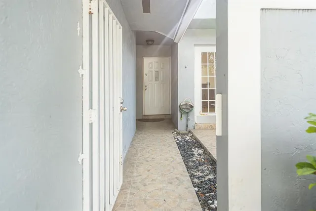 a view of a hallway with a dining area
