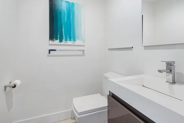 a bathroom with a sink a toilet and vanity