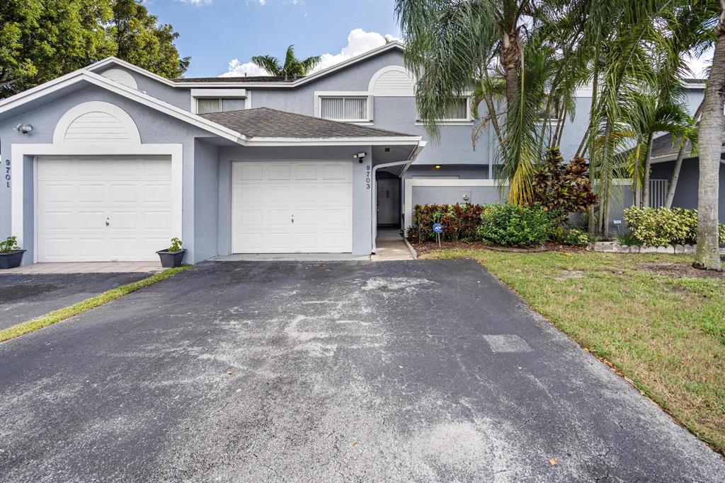 9703 Southwest 142nd Court Miami, FL 33186 - Photo 6 of 36 a view of a house with a yard and potted plants