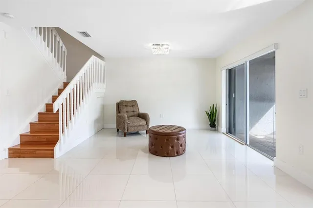 a living room with stairs and a couch