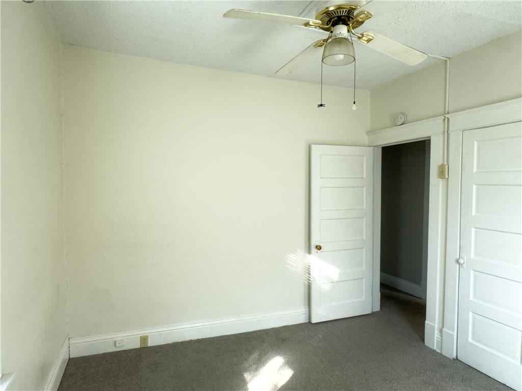 870 Chestnut Street Coplay, PA 18037 - Photo 12 of 24 A comfortable bedroom with carpet flooring and a practical ceiling fan.