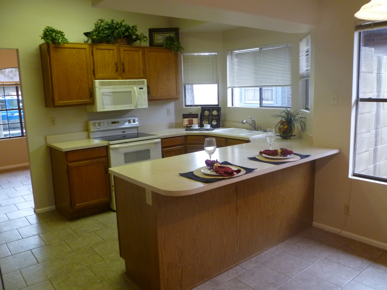 255 North Concord Street Gilbert, AZ 85234 - Photo 4 of 20 a kitchen with stainless steel appliances a sink a stove a refrigerator cabinets and a counter top space