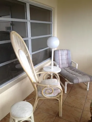 a living room with furniture and a lamp