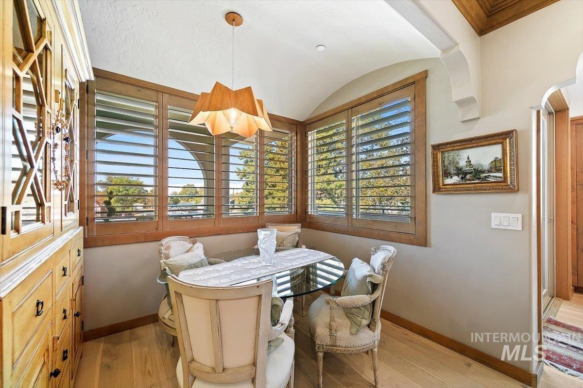 79 East Aikens Road, Unit 304 Eagle, ID 83616 - Photo 11 of 42 Wood-finish flooring, recessed lighting, arched entryway, plantation shutters, and wood trim detailing