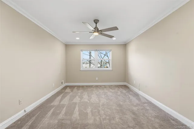an empty room with fan and windows