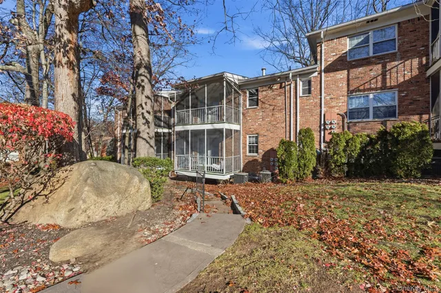 a view of a brick building next to a yard