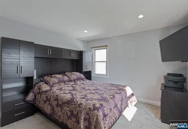 a bedroom with a bed and a television