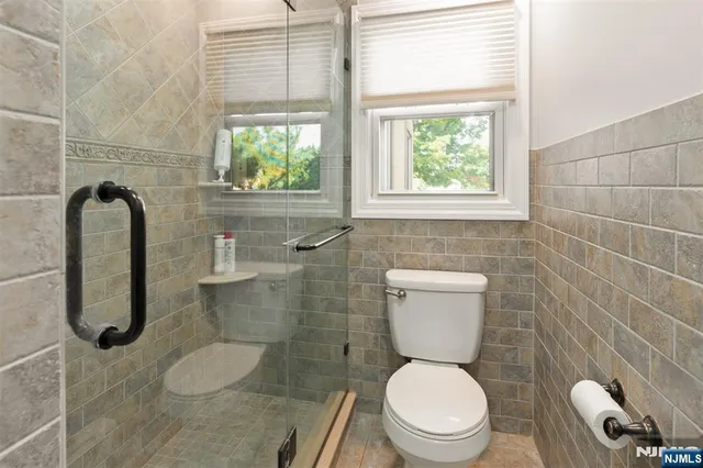 a white toilet sitting next to a window