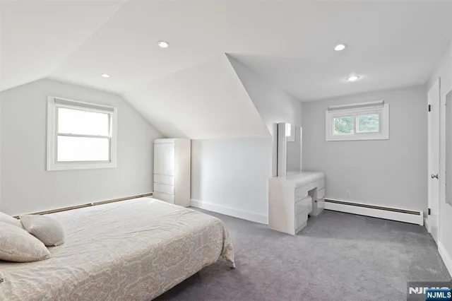 a spacious bedroom with a bed and a window