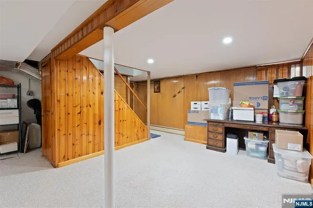 a view of an empty room with furniture and clothes