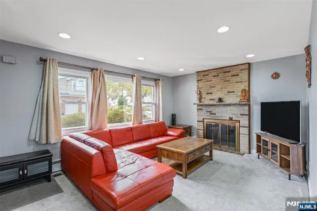 a living room with fireplace furniture and a flat screen tv