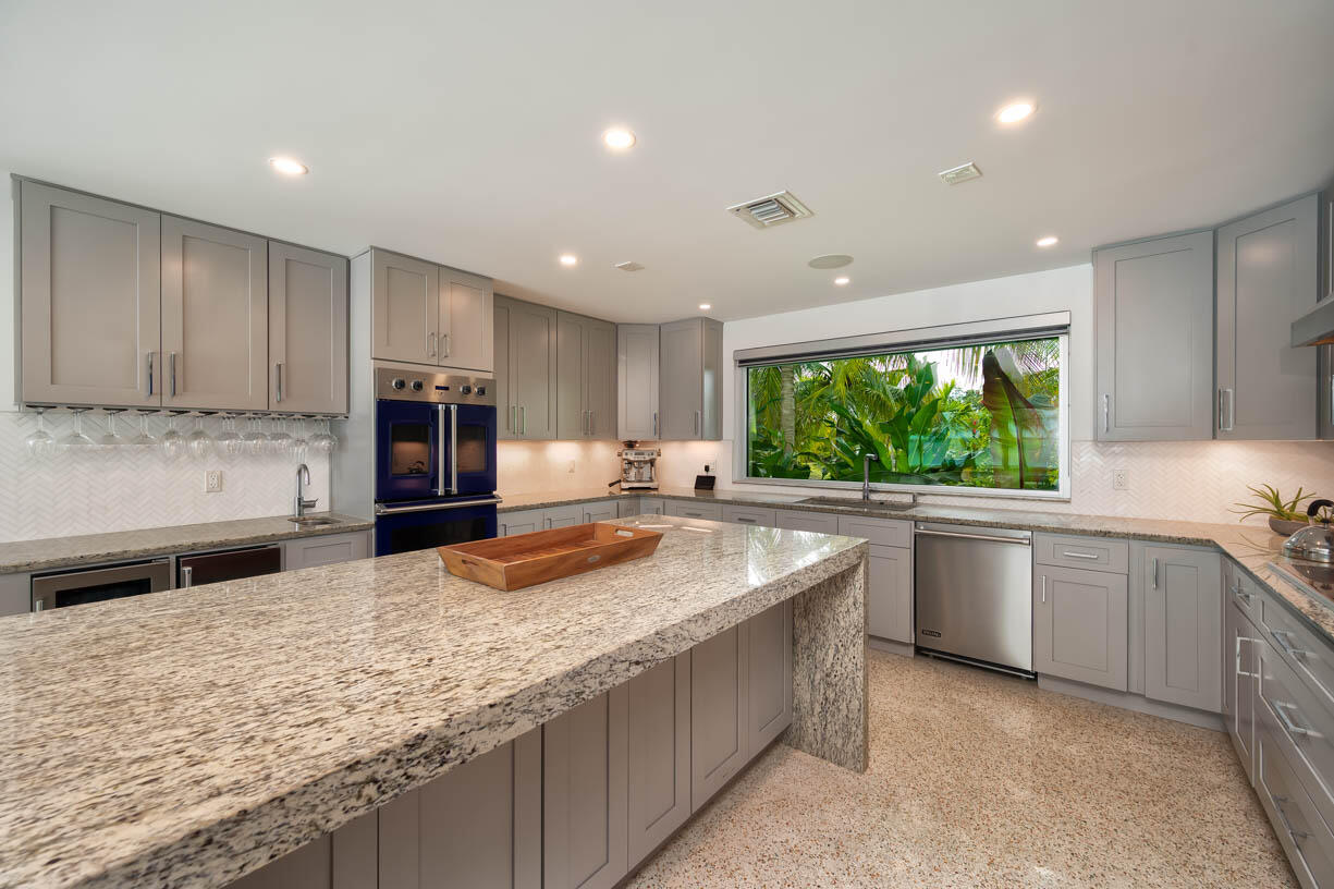 30680 Winifred Street Big Pine Key, FL 33043 - Photo 11 of 73 a kitchen with kitchen island granite countertop a stove sink and microwave