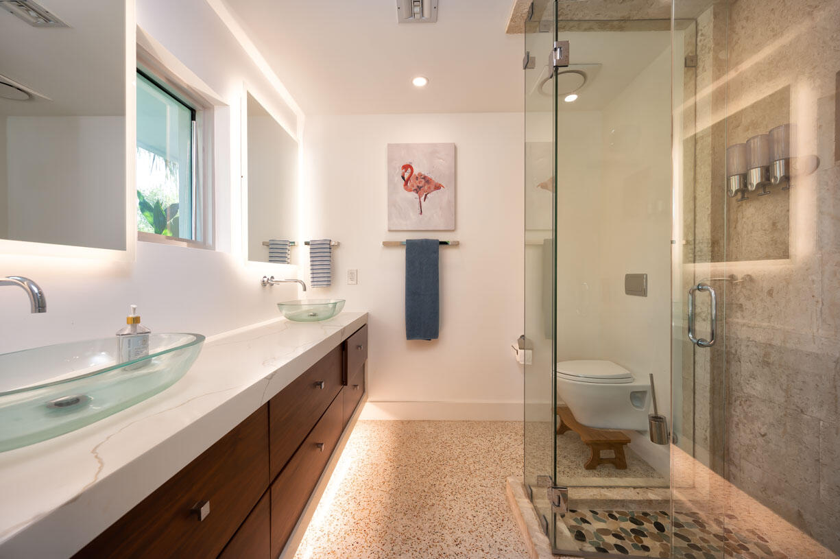 30680 Winifred Street Big Pine Key, FL 33043 - Photo 15 of 73 a spacious bathroom with a granite countertop sink a toilet a shower and a mirror