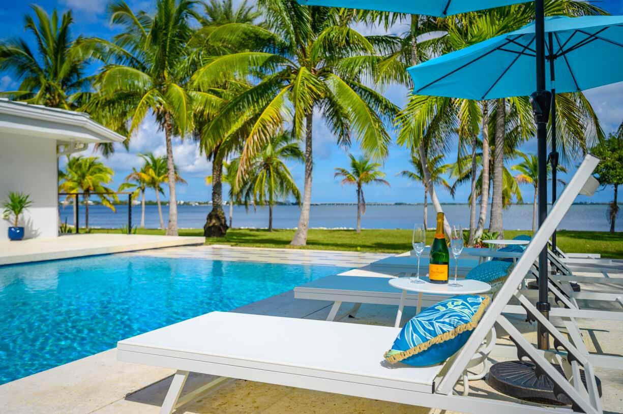 30680 Winifred Street Big Pine Key, FL 33043 - Photo 2 of 73 a view of swimming pool with chairs and table under an umbrella