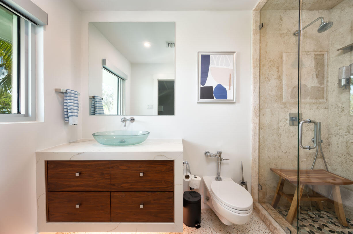 30680 Winifred Street Big Pine Key, FL 33043 - Photo 22 of 73 a bathroom with a toilet a sink and mirror