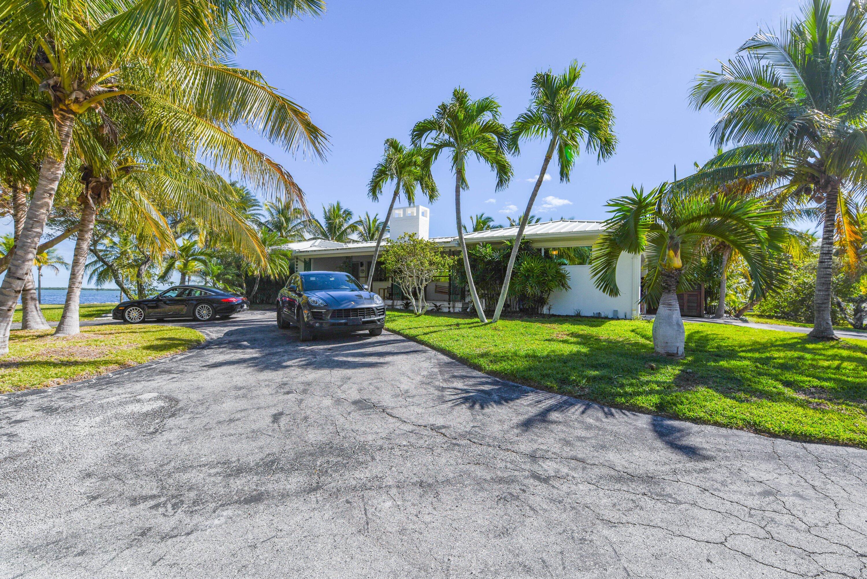 30680 Winifred Street Big Pine Key, FL 33043 - Photo 28 of 73 a front view of a house with a yard and palm trees
