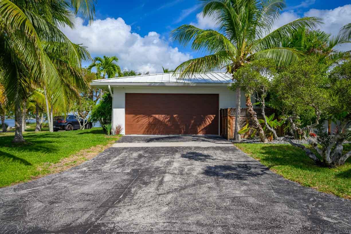 30680 Winifred Street Big Pine Key, FL 33043 - Photo 53 of 73 a view of a house with a yard and palm trees
