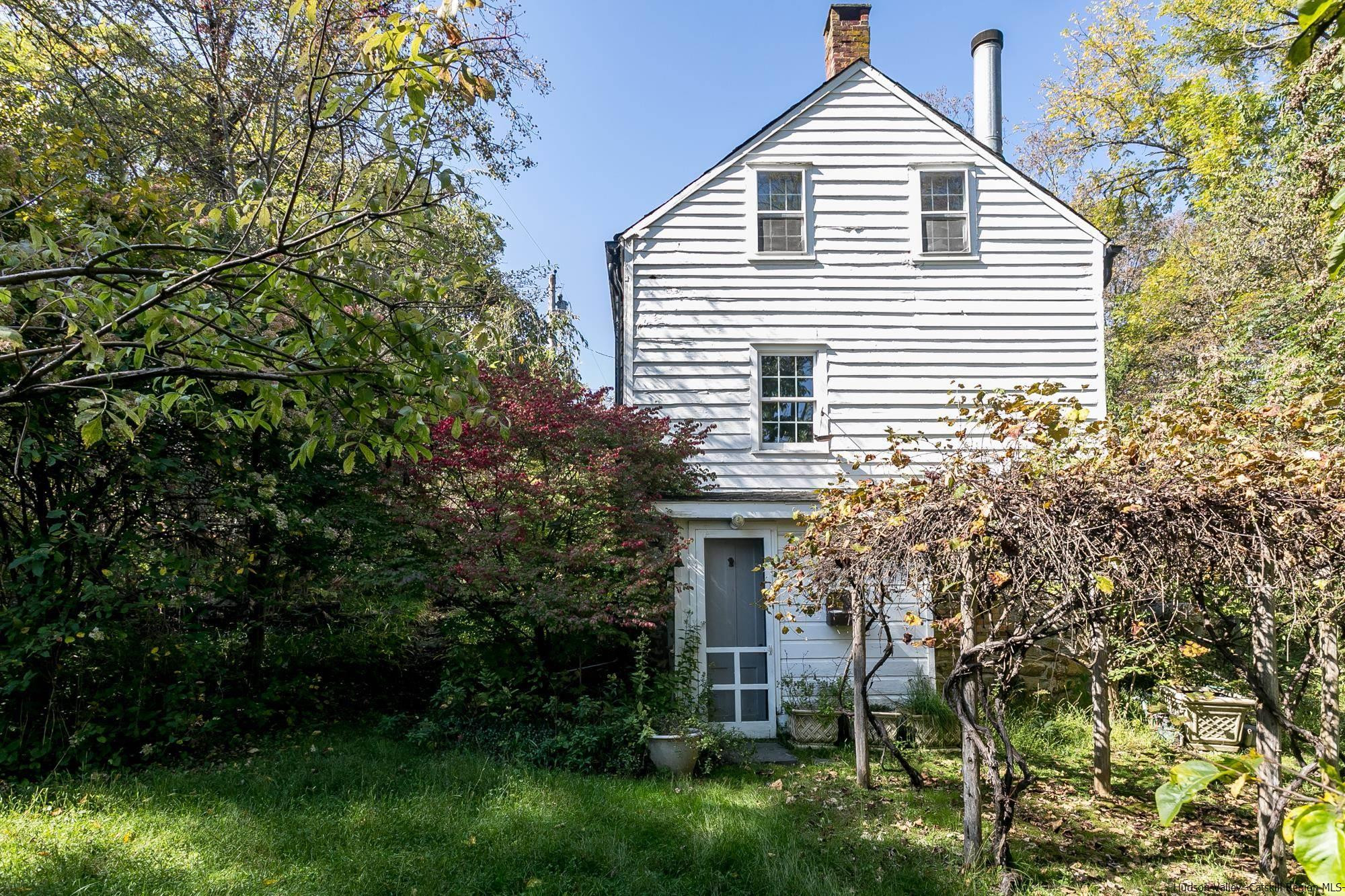 169 Marcott Road Kingston, NY 12401 - Photo 23 of 32 a view of a house with potted plants and a tree