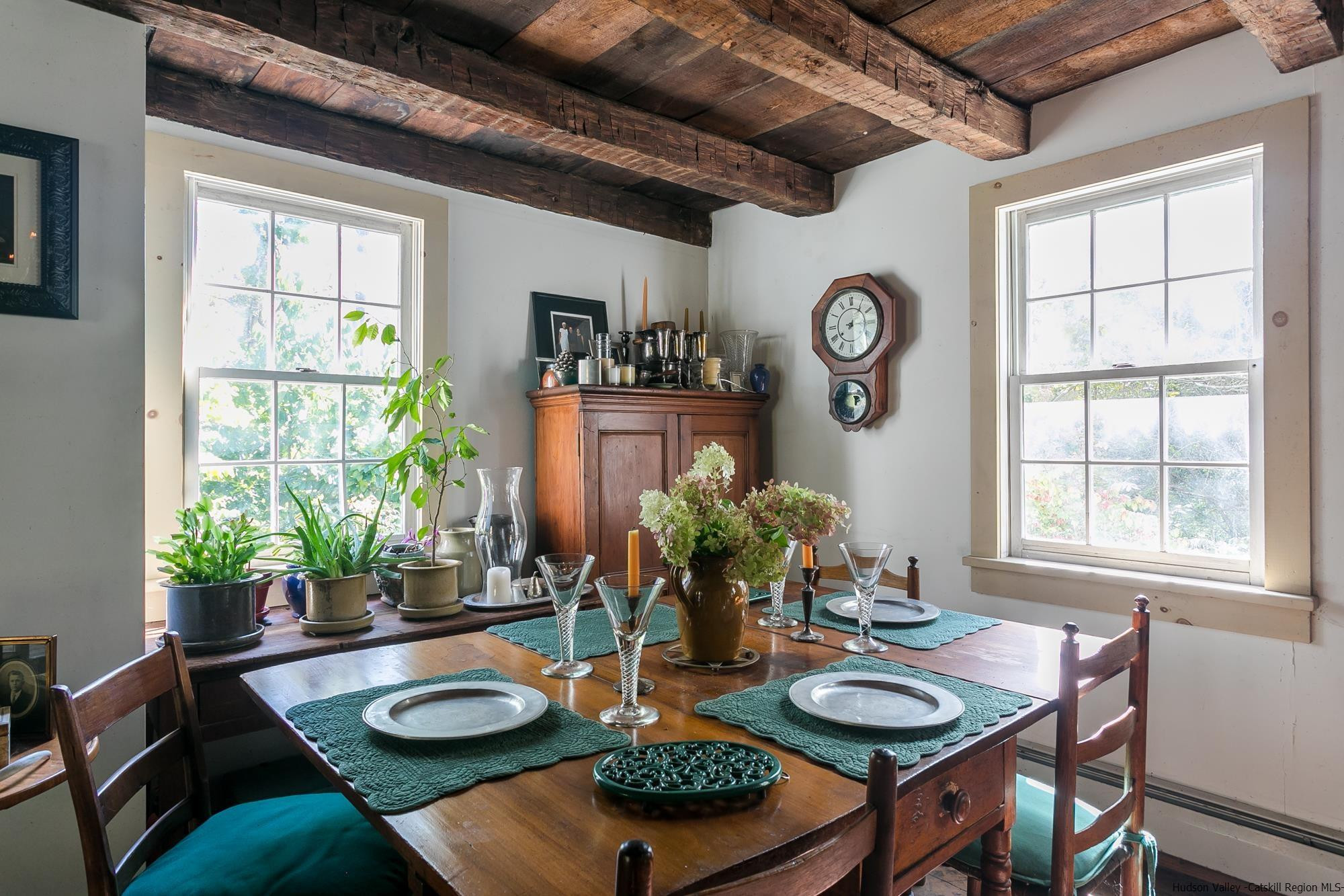 169 Marcott Road Kingston, NY 12401 - Photo 6 of 32 a dining room with furniture potted plants and wooden floor