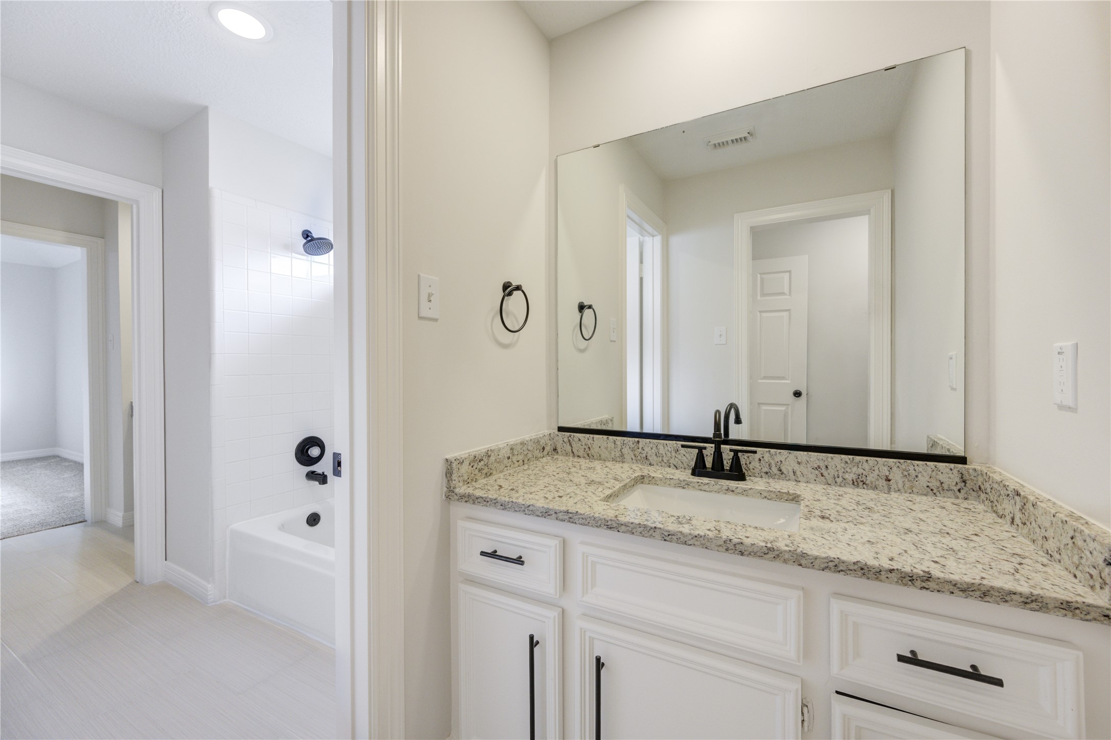 17318 Bonnard Circle Spring, TX 77379 - Photo 32 of 45 Jack and Jill Bathroom - Adjacent to Bedroom 2. All bathrooms have new granite, sink, faucets, towel bars, and cabinet pulls. This bathroom also has new 24" stylish tile flooring too!