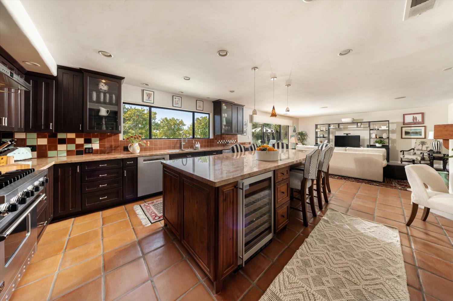 1213 San Ramon Way Ojai, CA 93023 - Photo 10 of 35 a kitchen with stainless steel appliances granite countertop a stove top oven a sink dishwasher and cabinets with wooden floor