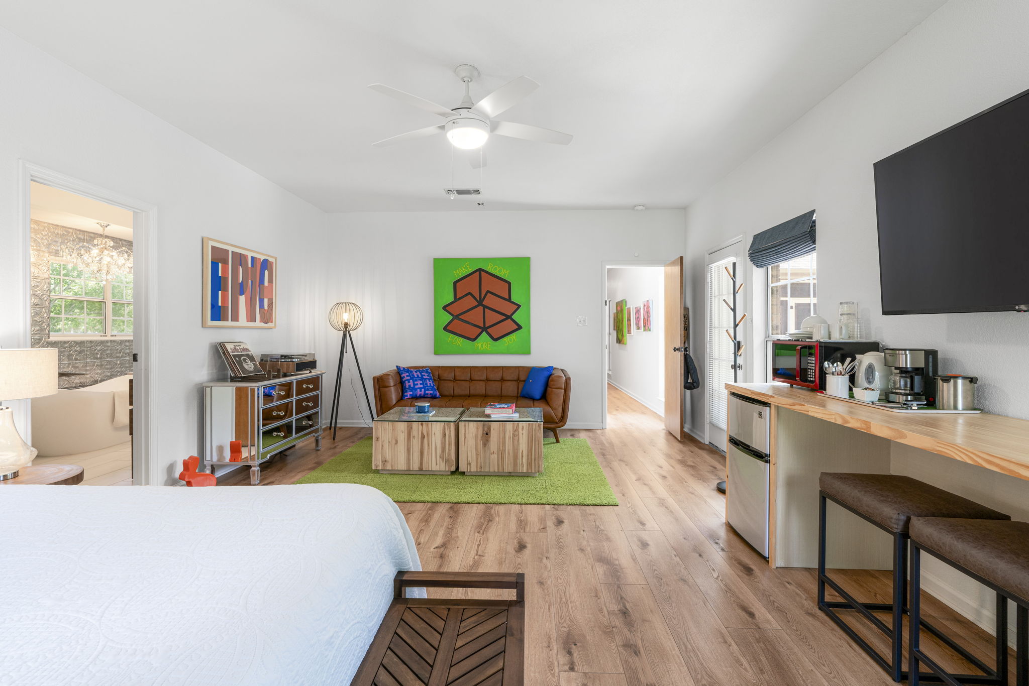 400 Hackberry Street Lockhart, TX 78644 - Photo 22 of 40 An inviting open-concept living space features warm wood flooring and a streamlined wet bar.