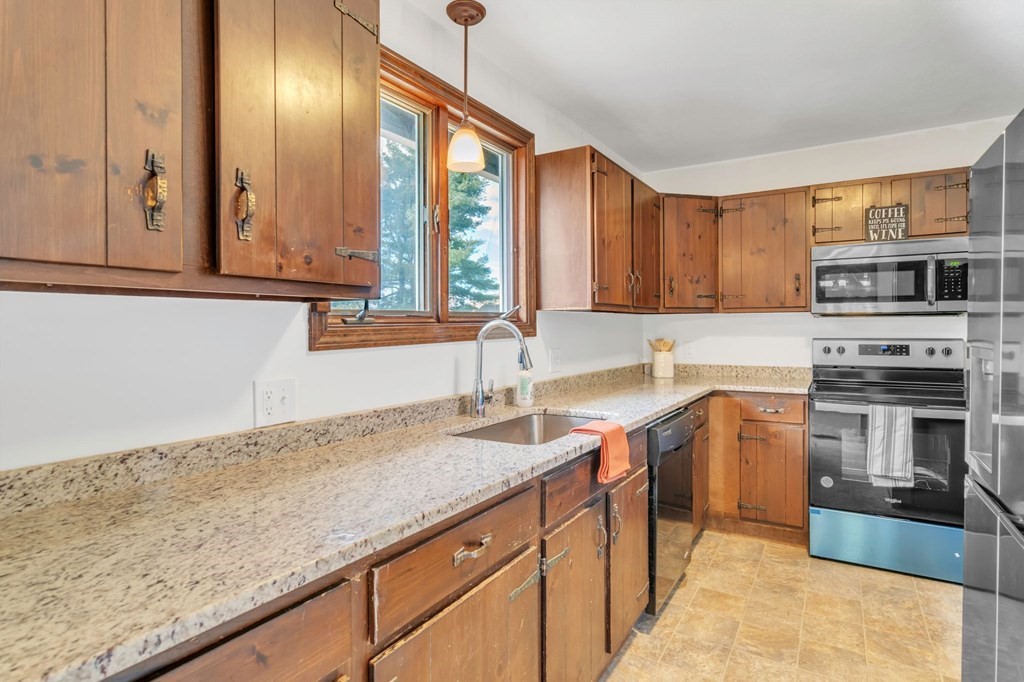 145 Chester Road Blandford, MA 01008 - Photo 23 of 34 a kitchen with stainless steel appliances granite countertop a sink a stove and a refrigerator
