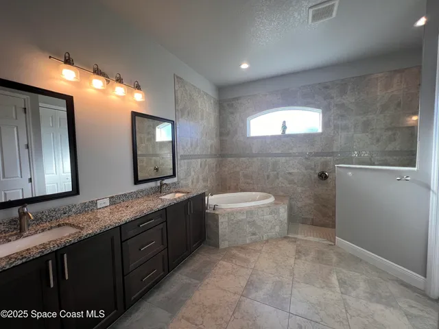 a bathroom with a granite countertop sink a toilet and mirror