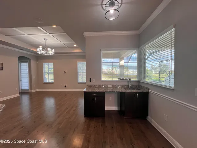 a large kitchen with stainless steel appliances granite countertop a stove and cabinets with wooden floor