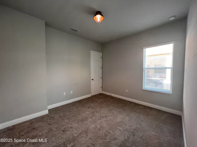 an empty room with windows and view